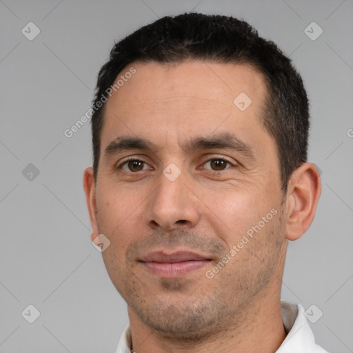 Joyful white young-adult male with short  black hair and brown eyes