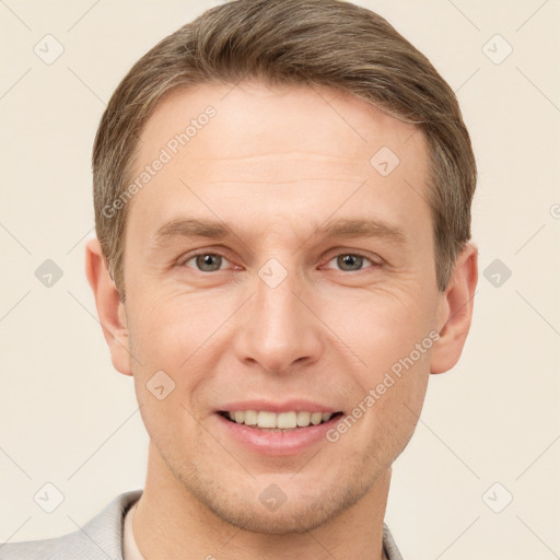 Joyful white adult male with short  brown hair and brown eyes