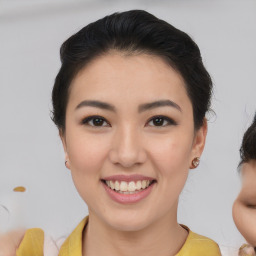 Joyful asian young-adult female with medium  brown hair and brown eyes