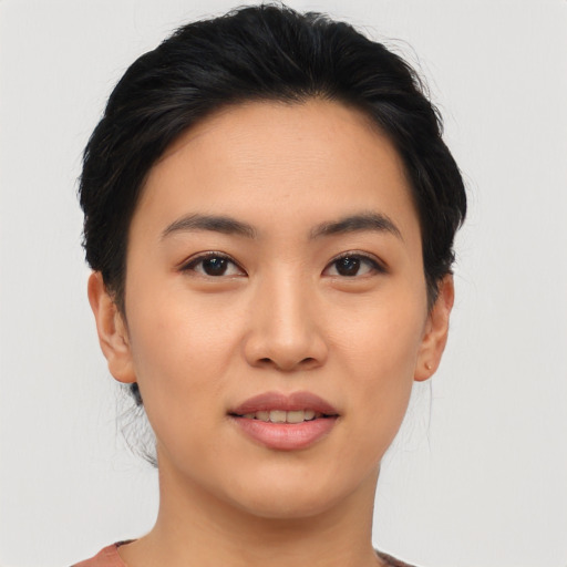 Joyful asian young-adult female with short  brown hair and brown eyes