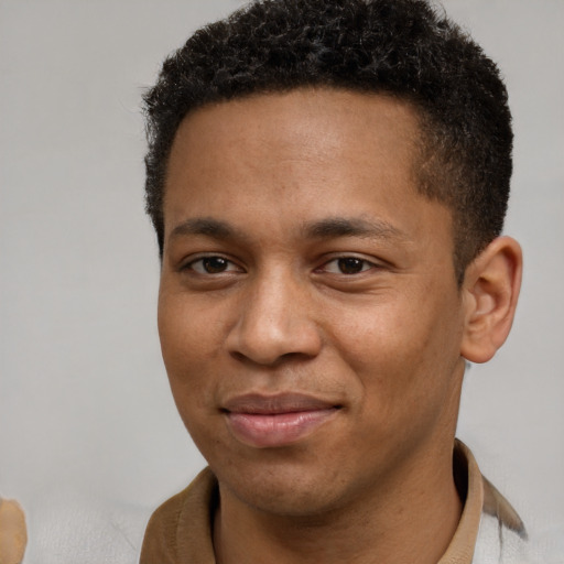 Joyful black young-adult male with short  brown hair and brown eyes