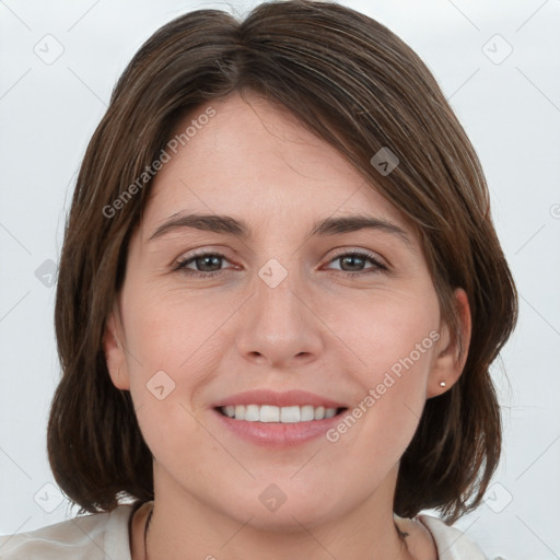 Joyful white young-adult female with medium  brown hair and grey eyes