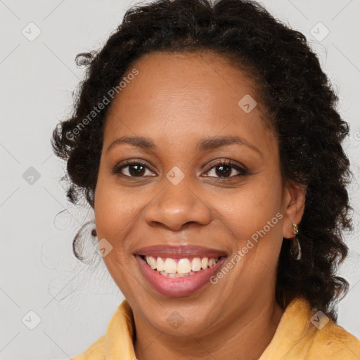 Joyful black young-adult female with long  brown hair and brown eyes