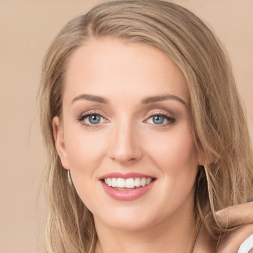 Joyful white young-adult female with long  brown hair and green eyes