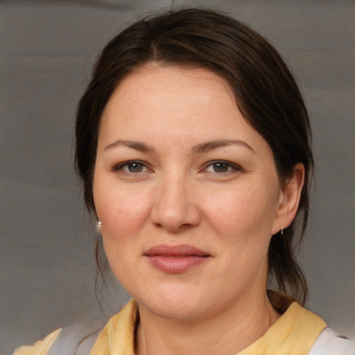 Joyful white adult female with medium  brown hair and brown eyes