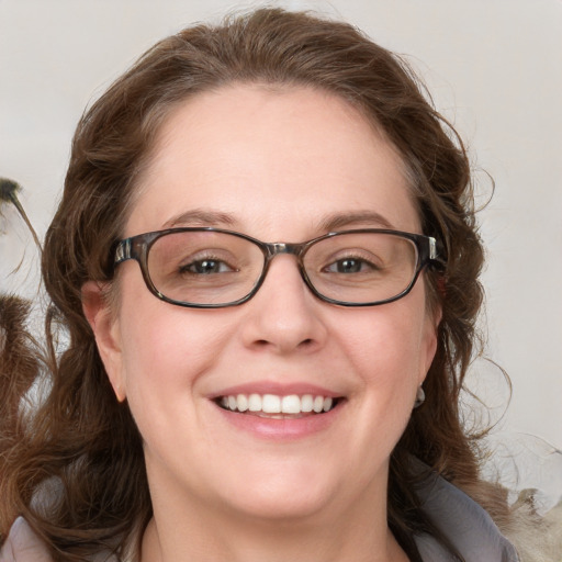 Joyful white adult female with medium  brown hair and blue eyes