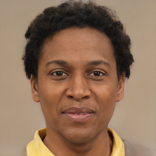 Joyful black adult male with short  brown hair and brown eyes