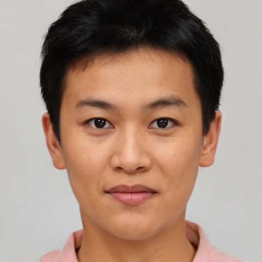 Joyful asian young-adult male with short  black hair and brown eyes