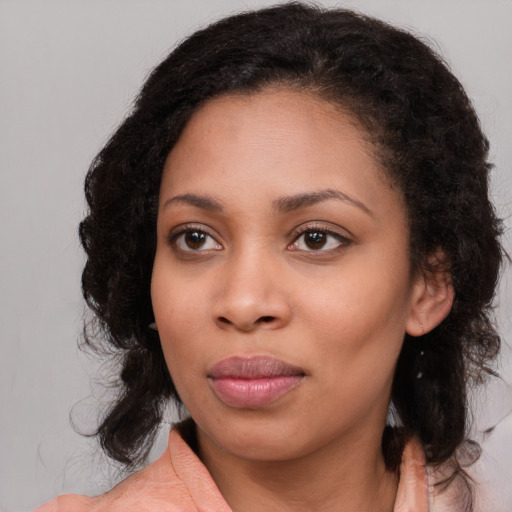 Joyful black young-adult female with medium  brown hair and brown eyes