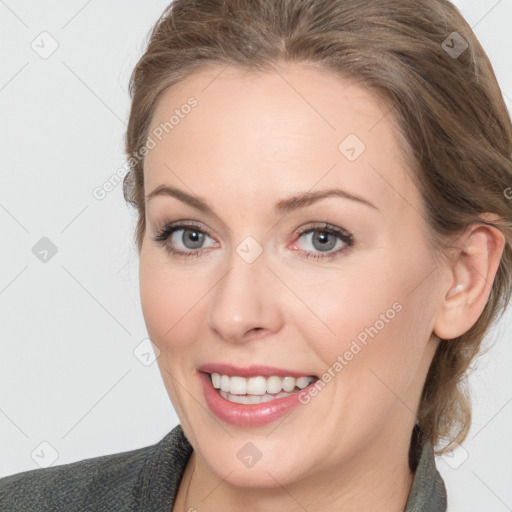 Joyful white young-adult female with medium  brown hair and grey eyes