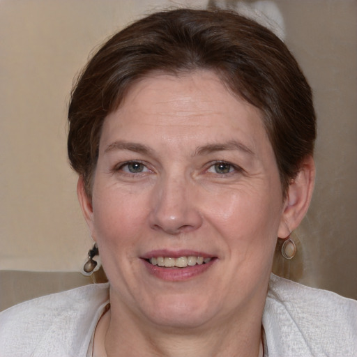 Joyful white adult female with medium  brown hair and blue eyes