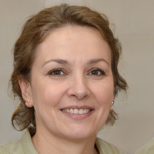 Joyful white adult female with medium  brown hair and brown eyes