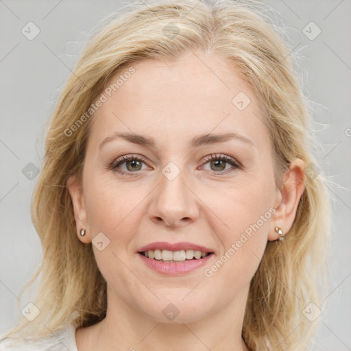 Joyful white adult female with medium  brown hair and blue eyes