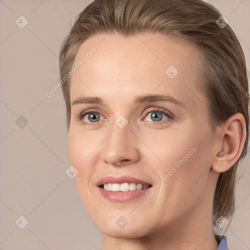 Joyful white young-adult female with medium  brown hair and grey eyes