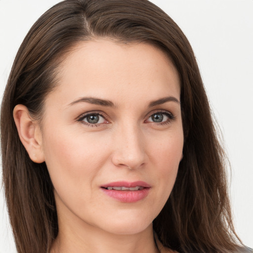 Joyful white young-adult female with long  brown hair and grey eyes