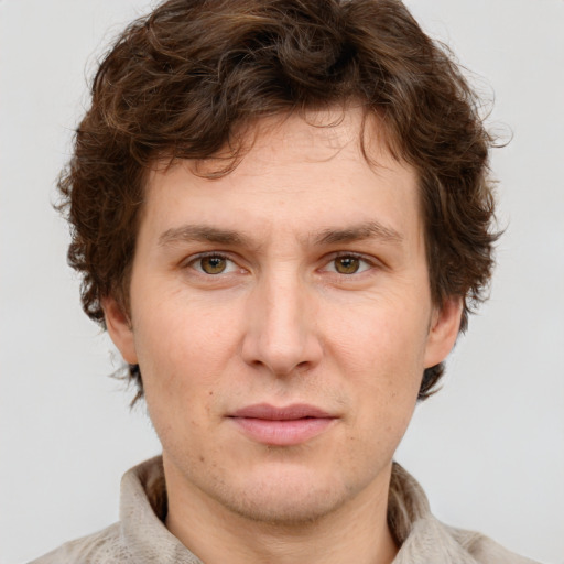 Joyful white young-adult male with short  brown hair and green eyes