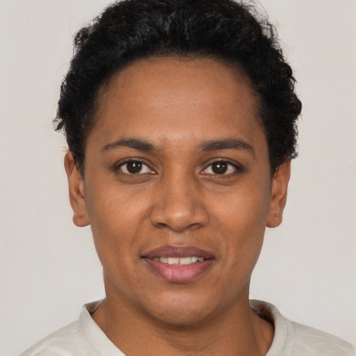 Joyful black young-adult female with short  brown hair and brown eyes