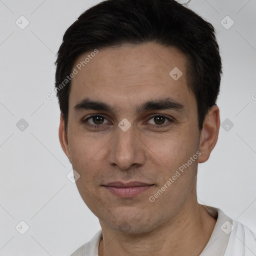 Joyful white young-adult male with short  black hair and brown eyes