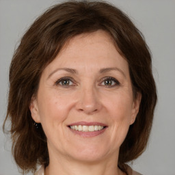 Joyful white adult female with medium  brown hair and brown eyes