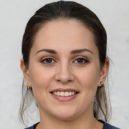 Joyful white young-adult female with medium  brown hair and brown eyes