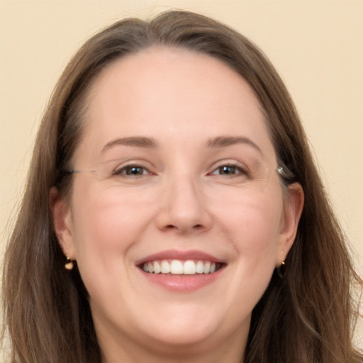 Joyful white adult female with long  brown hair and grey eyes