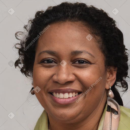 Joyful black young-adult female with long  brown hair and brown eyes