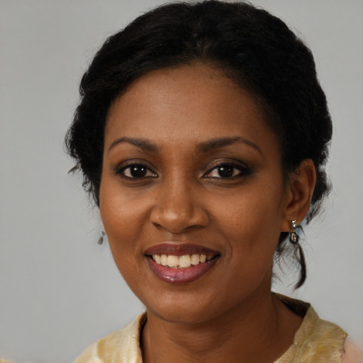Joyful black young-adult female with medium  black hair and brown eyes