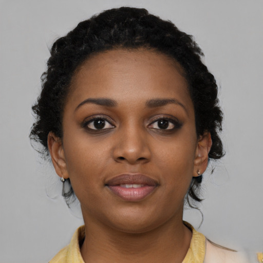 Joyful black young-adult female with medium  brown hair and brown eyes
