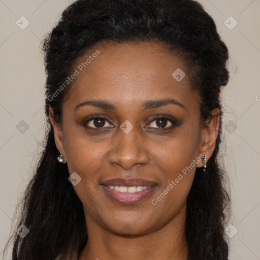 Joyful black young-adult female with long  brown hair and brown eyes