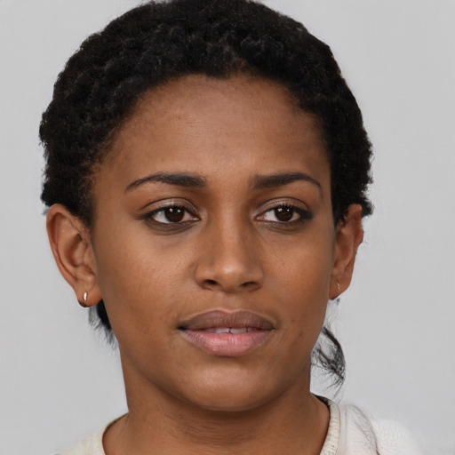 Joyful black young-adult female with short  brown hair and brown eyes
