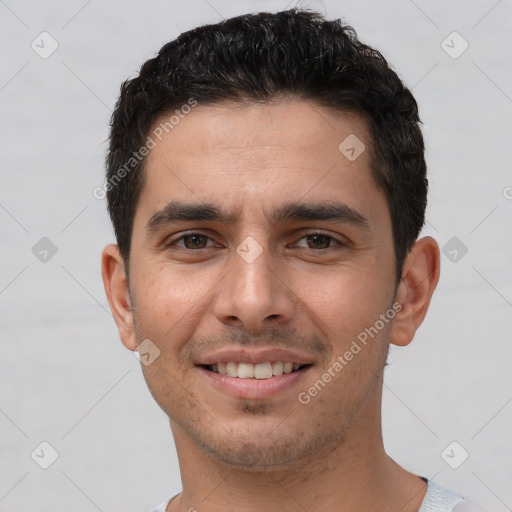 Joyful white young-adult male with short  black hair and brown eyes