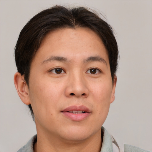 Joyful white adult male with short  brown hair and brown eyes