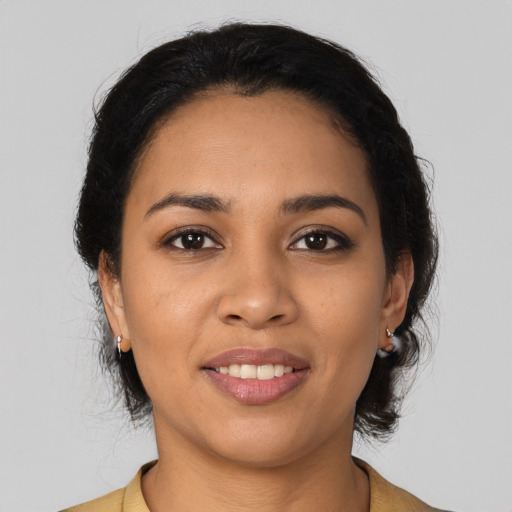 Joyful latino young-adult female with medium  brown hair and brown eyes