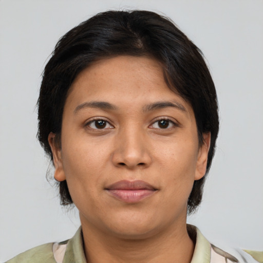 Joyful latino young-adult female with medium  brown hair and brown eyes