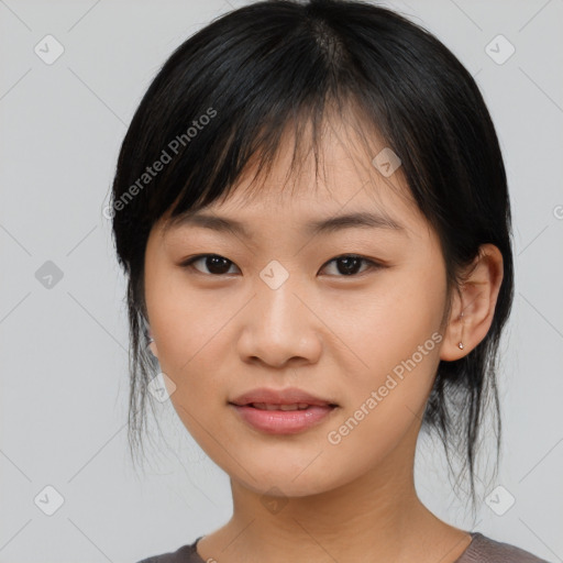 Joyful asian young-adult female with medium  black hair and brown eyes