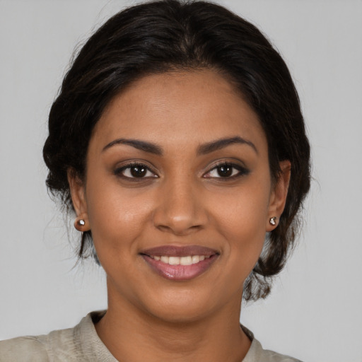 Joyful black young-adult female with medium  brown hair and brown eyes