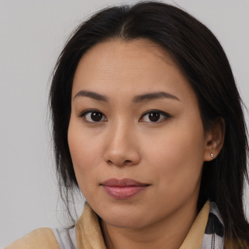 Joyful asian young-adult female with long  brown hair and brown eyes