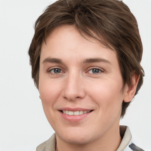 Joyful white young-adult female with short  brown hair and grey eyes