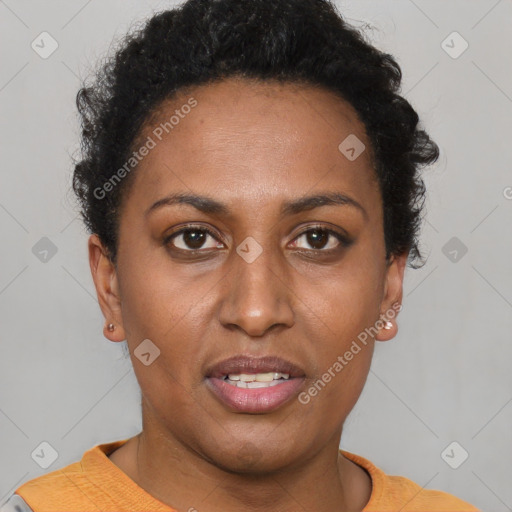 Joyful black young-adult female with short  brown hair and brown eyes