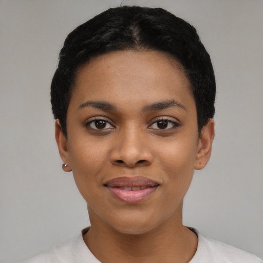 Joyful black young-adult female with short  black hair and brown eyes