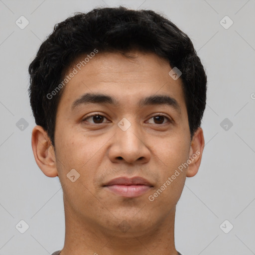 Joyful latino young-adult male with short  brown hair and brown eyes