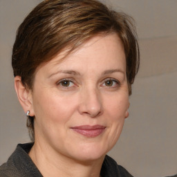 Joyful white adult female with medium  brown hair and grey eyes