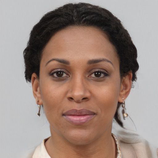 Joyful black adult female with short  brown hair and brown eyes