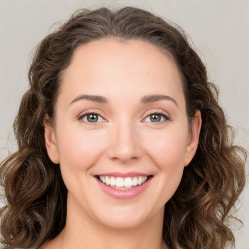 Joyful white young-adult female with long  brown hair and green eyes