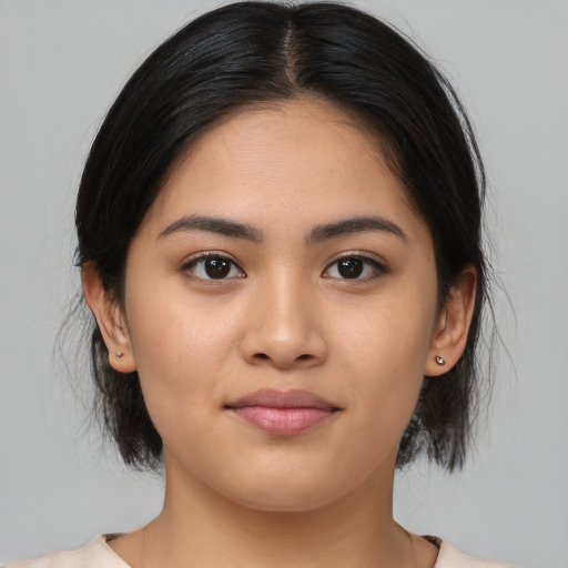 Joyful asian young-adult female with medium  brown hair and brown eyes