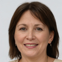 Joyful white adult female with medium  brown hair and grey eyes