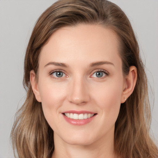 Joyful white young-adult female with long  brown hair and grey eyes