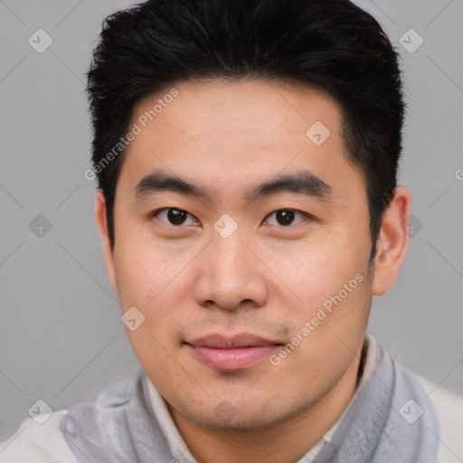 Joyful asian young-adult male with short  brown hair and brown eyes