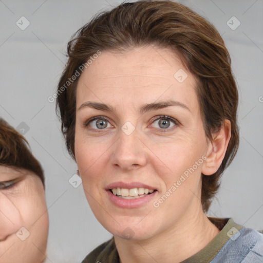 Joyful white adult female with medium  brown hair and blue eyes