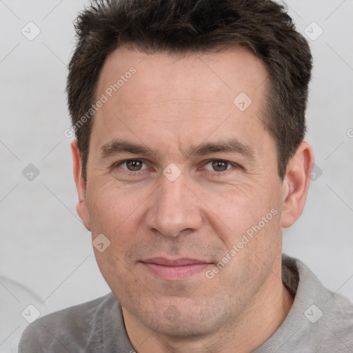 Joyful white adult male with short  brown hair and brown eyes